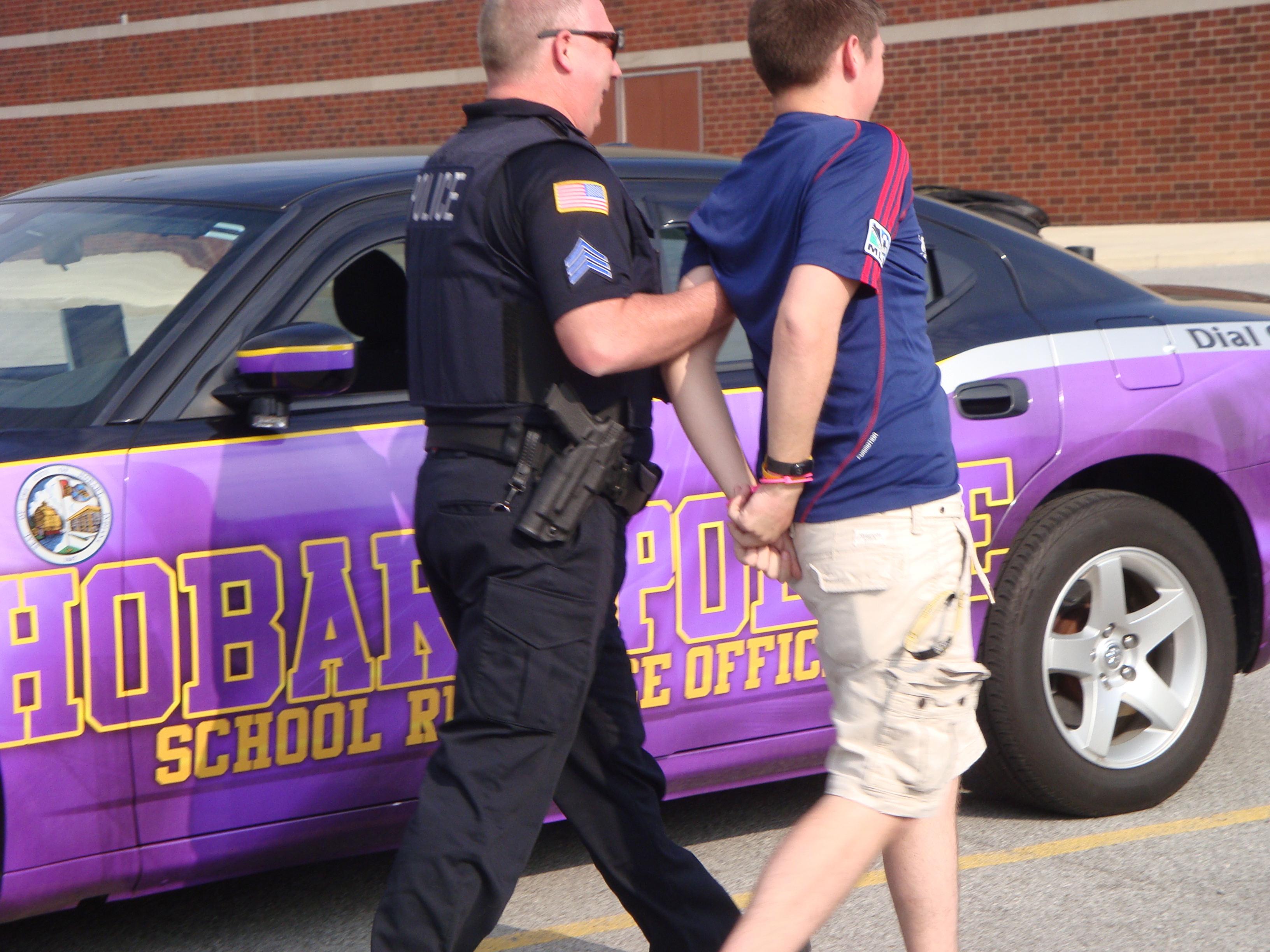 Police officer escorting student
